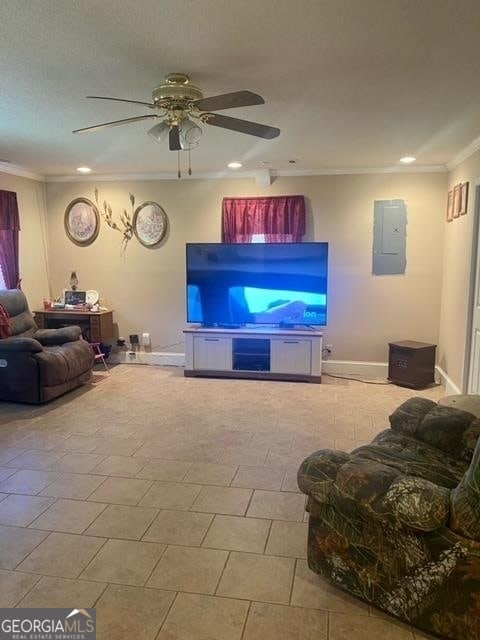 tiled living room with ornamental molding and ceiling fan