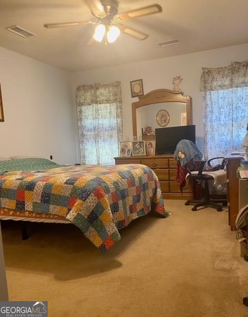 carpeted bedroom featuring ceiling fan