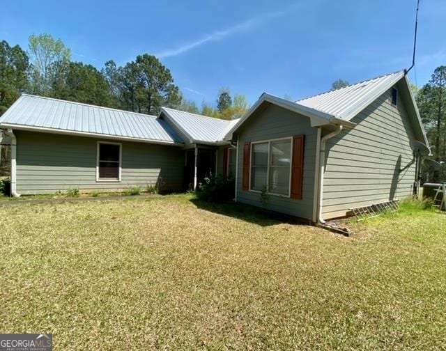 rear view of house with a lawn