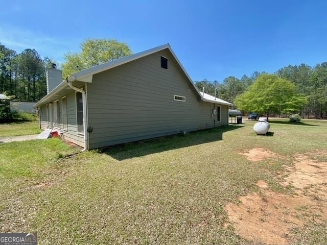 view of side of home featuring a lawn