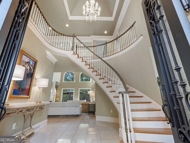 entrance foyer with a notable chandelier, a towering ceiling, and light tile patterned flooring