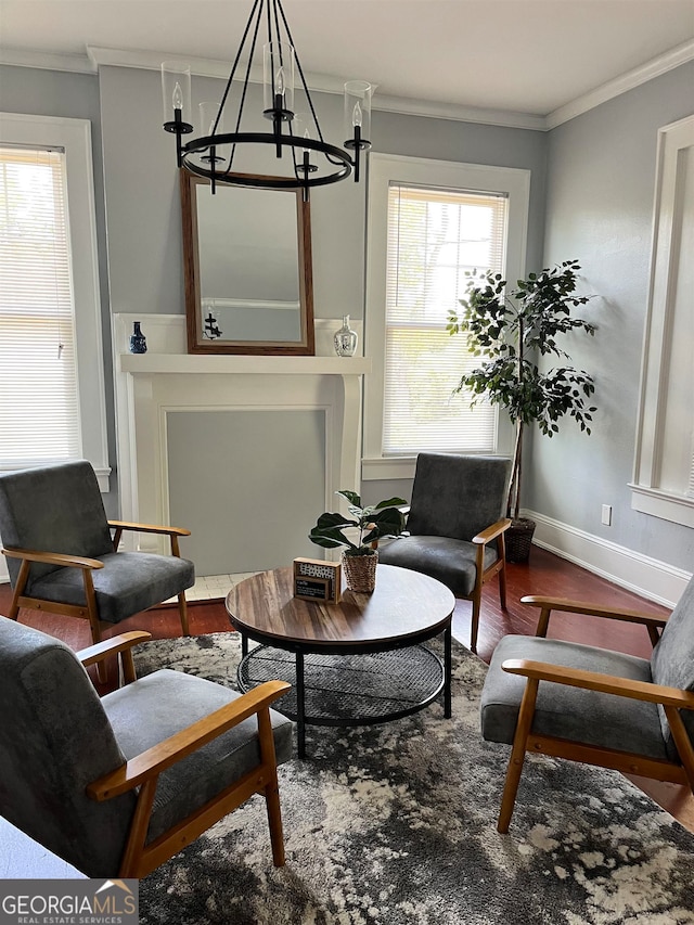 living area with crown molding, a wealth of natural light, and hardwood / wood-style flooring