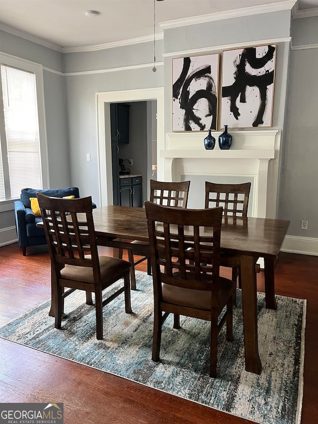 dining area with dark hardwood / wood-style flooring and ornamental molding