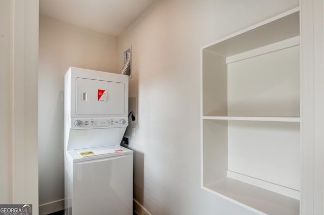 laundry room with stacked washing maching and dryer