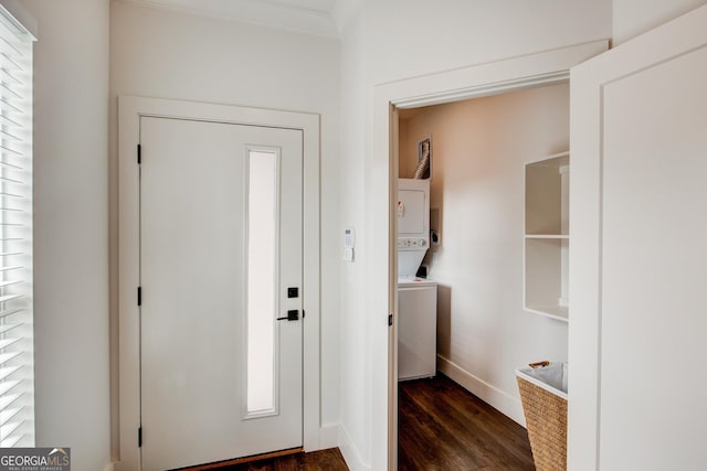 entryway with dark hardwood / wood-style flooring, stacked washer / drying machine, and ornamental molding