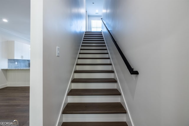 stairway with hardwood / wood-style floors