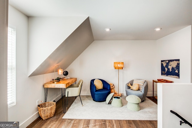 sitting room featuring wood-type flooring and a healthy amount of sunlight