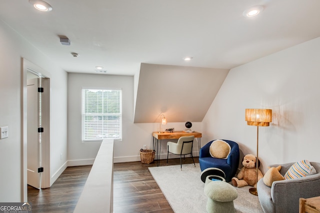 living area with dark wood-type flooring and vaulted ceiling