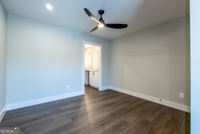 unfurnished bedroom featuring dark hardwood / wood-style flooring, ensuite bath, and ceiling fan