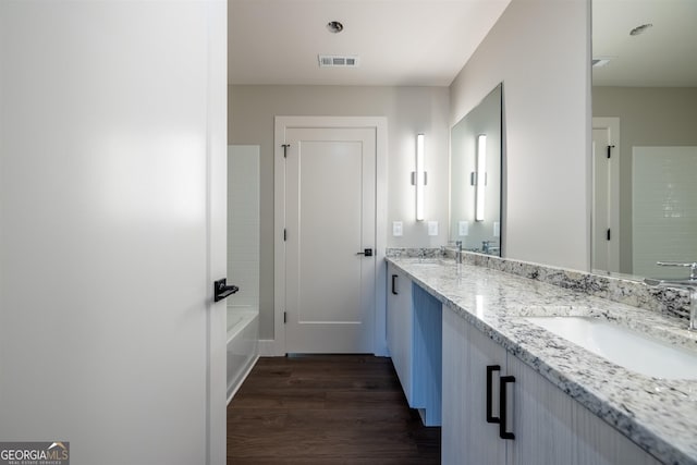 bathroom featuring hardwood / wood-style flooring and vanity