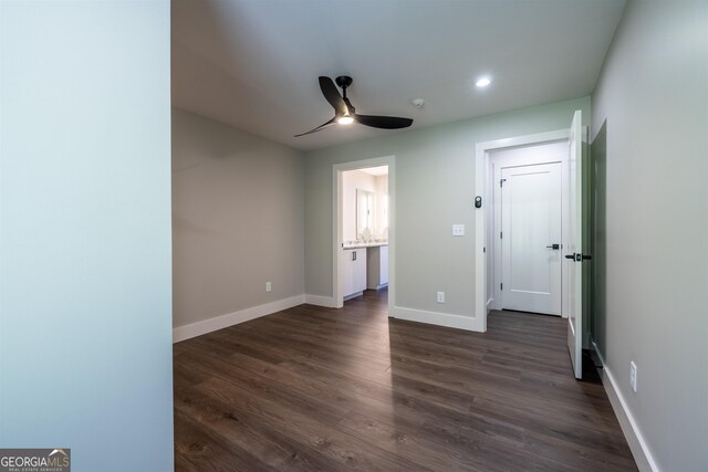 unfurnished bedroom featuring ceiling fan and dark wood-type flooring