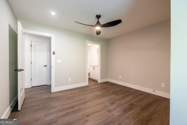 unfurnished bedroom with dark hardwood / wood-style flooring, ensuite bathroom, and ceiling fan