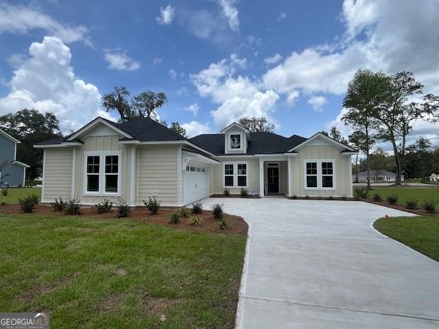 view of front facade with a garage and a front lawn