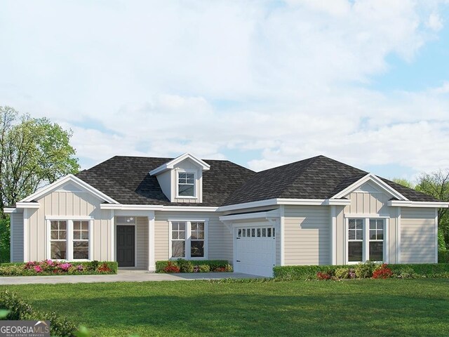 view of front of property with a garage and a front lawn