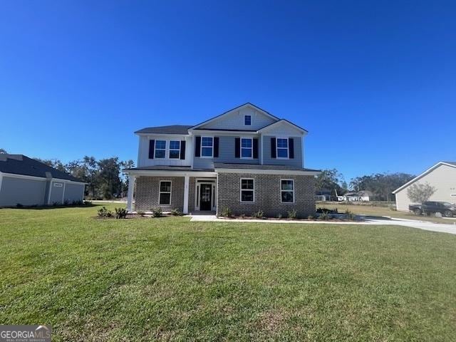 35 Fairwinds Unit 207, Waverly, GA 31565 - view of front of property with brick siding, a front lawn, and covered porch
