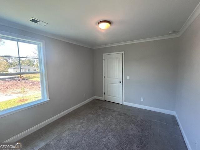 35 Fairwinds Unit 207, Waverly, GA 31565 - unfurnished room featuring crown molding, baseboards, dark colored carpet, and visible vents