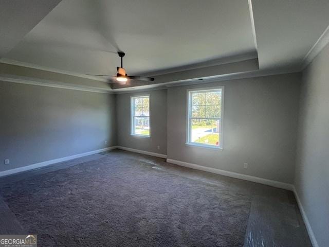 35 Fairwinds Unit 207, Waverly, GA 31565 - carpeted empty room with crown molding, a ceiling fan, a tray ceiling, and baseboards