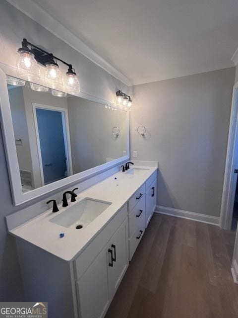 35 Fairwinds Unit 207, Waverly, GA 31565 - bathroom with double vanity, baseboards, a sink, and wood finished floors