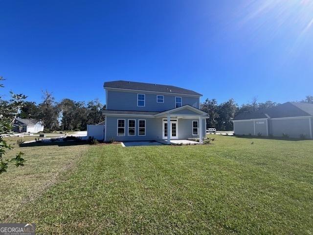 35 Fairwinds Unit 207, Waverly, GA 31565 - rear view of house with a yard and a patio area