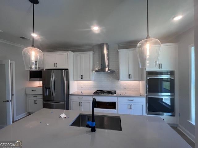 35 Fairwinds Unit 207, Waverly, GA 31565 - kitchen with a sink, appliances with stainless steel finishes, white cabinets, and wall chimney range hood