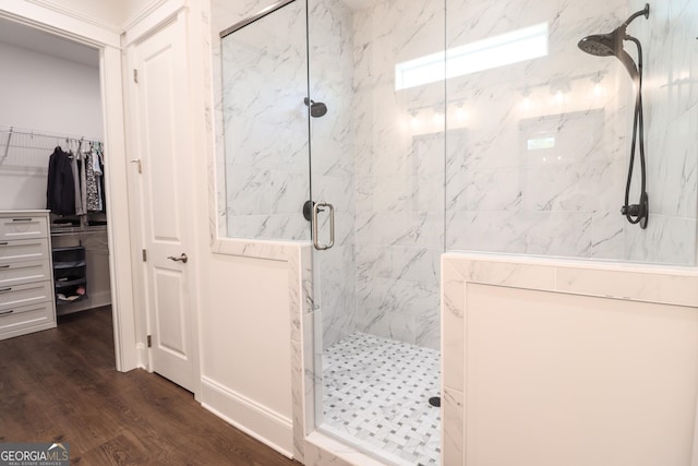 bathroom with wood-type flooring and an enclosed shower