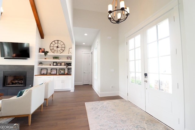 foyer entrance featuring vaulted ceiling with beams, a chandelier, and dark wood-type flooring