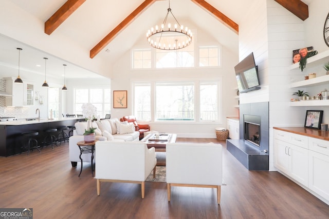 living room with high vaulted ceiling, beam ceiling, dark hardwood / wood-style floors, and a tiled fireplace