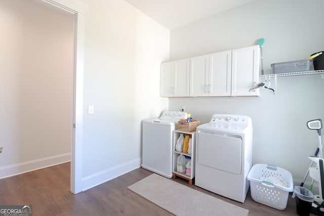 clothes washing area with dark hardwood / wood-style floors, cabinets, and independent washer and dryer