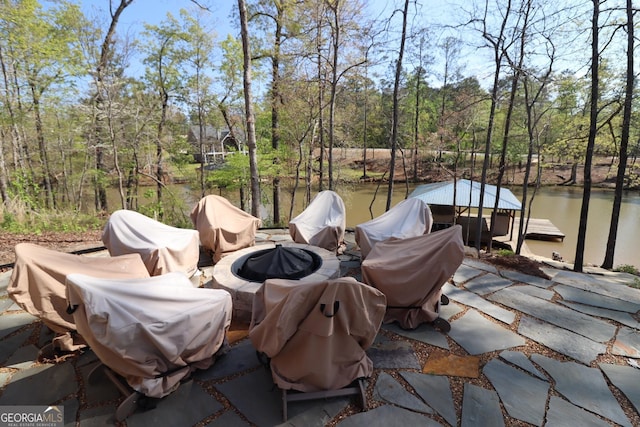 view of patio featuring a water view and a boat dock