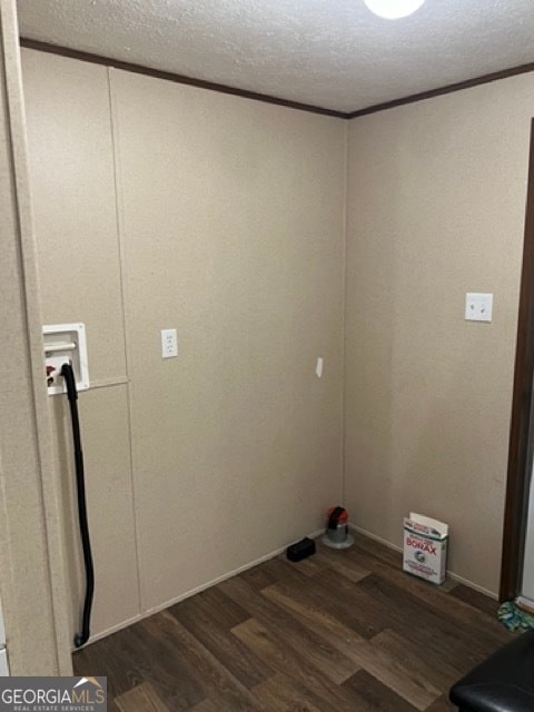 clothes washing area with washer hookup, dark hardwood / wood-style flooring, and a textured ceiling