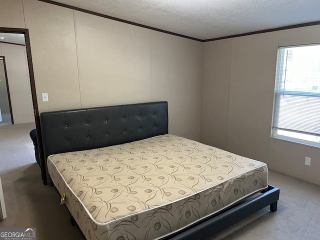 bedroom with a textured ceiling and carpet