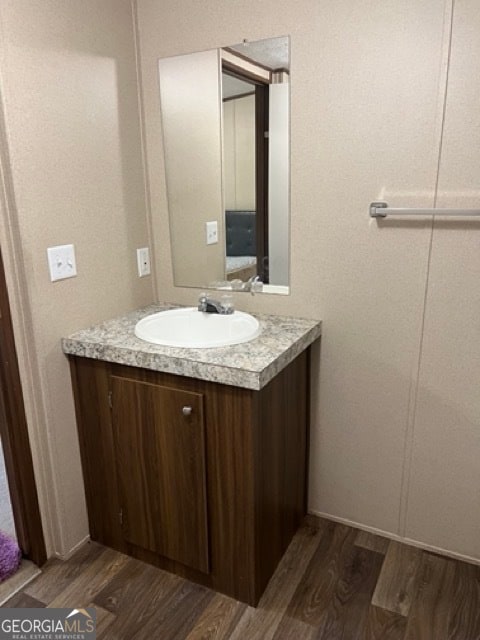 bathroom featuring hardwood / wood-style flooring and vanity