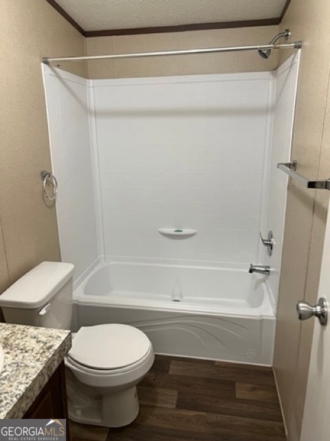 full bathroom featuring  shower combination, hardwood / wood-style flooring, toilet, and vanity