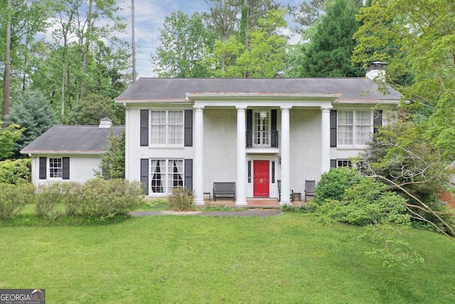 greek revival inspired property with a front lawn