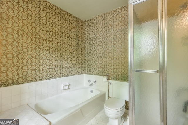 bathroom with toilet, tile patterned flooring, and separate shower and tub