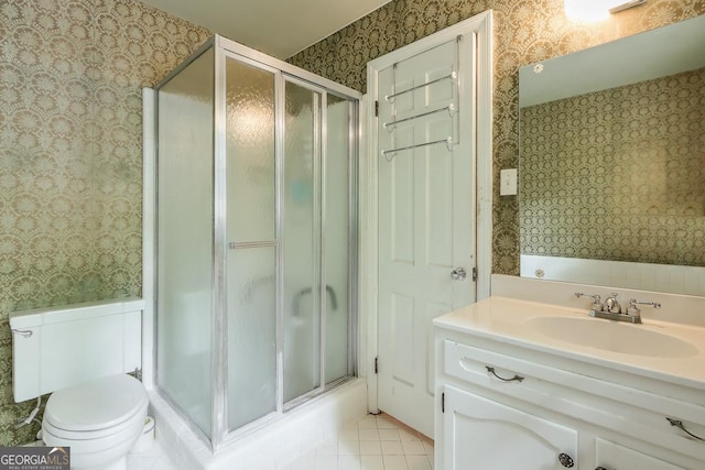 bathroom with a shower with door, tile patterned flooring, vanity, and toilet