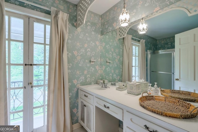 bathroom with an enclosed shower, french doors, and vanity