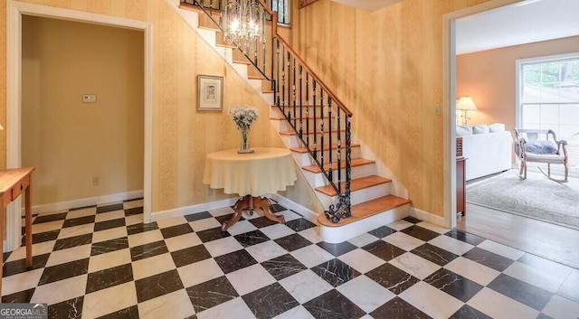 staircase featuring a chandelier