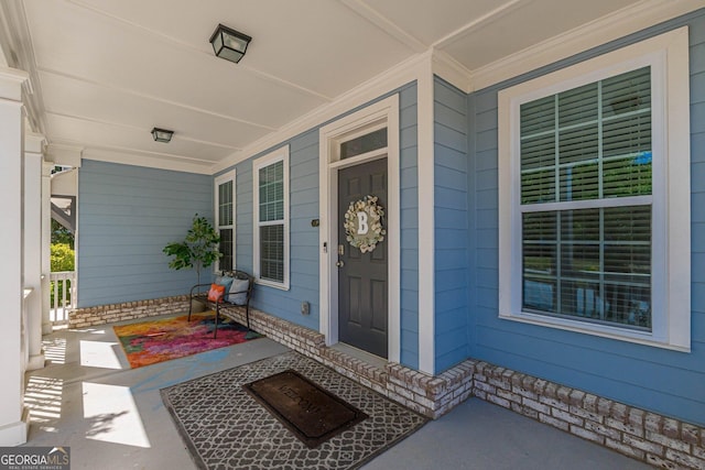 view of exterior entry with a porch