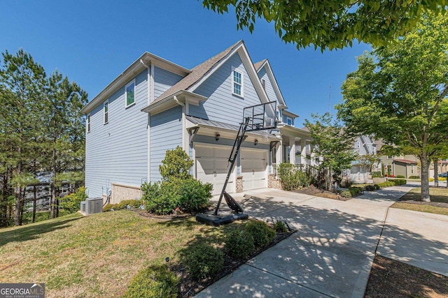 view of front of property with a front lawn, a garage, and central air condition unit