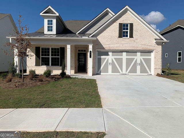 view of front of home with a front yard and a garage