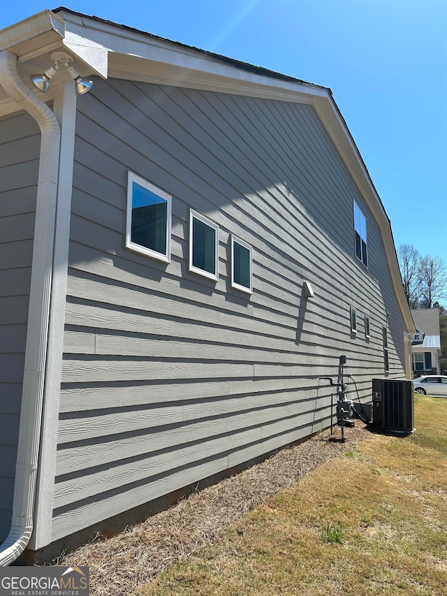 view of side of home featuring central AC unit