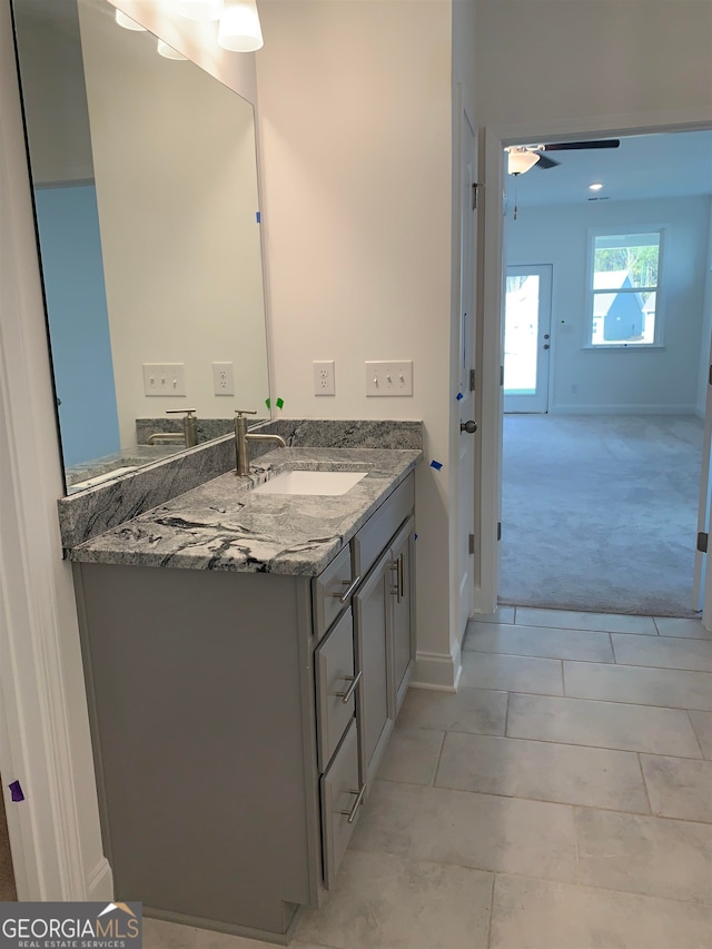 bathroom with ceiling fan, tile flooring, and vanity