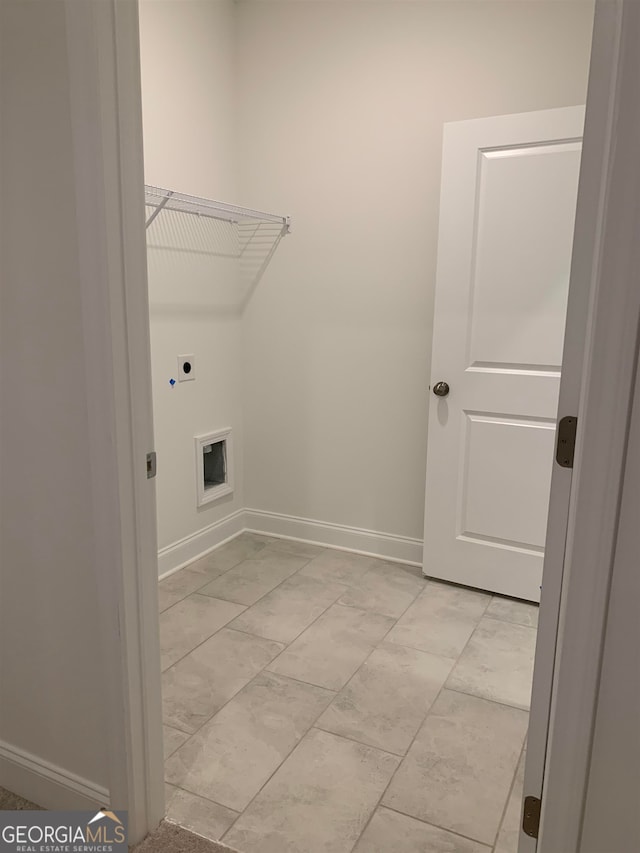 washroom featuring hookup for an electric dryer and light tile floors