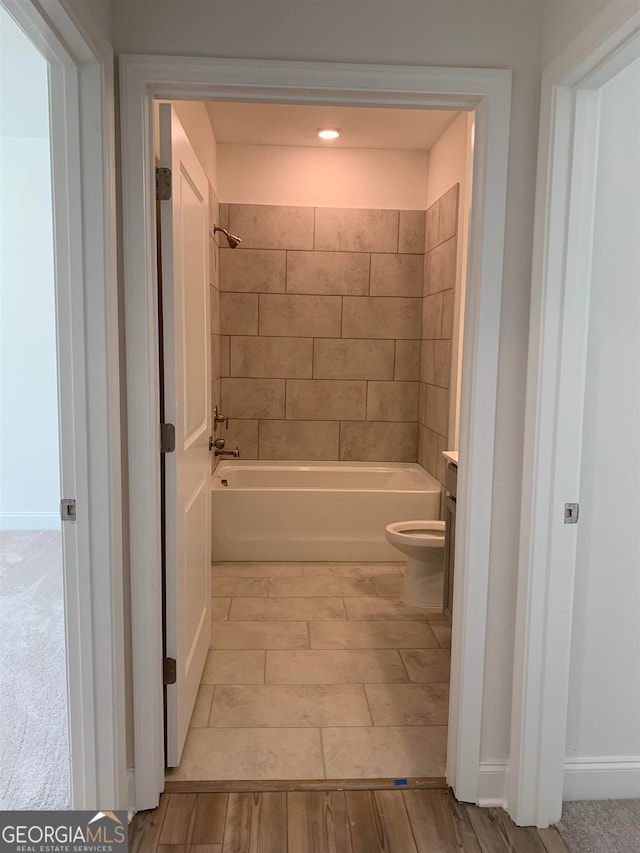 bathroom featuring shower / bath combination and toilet