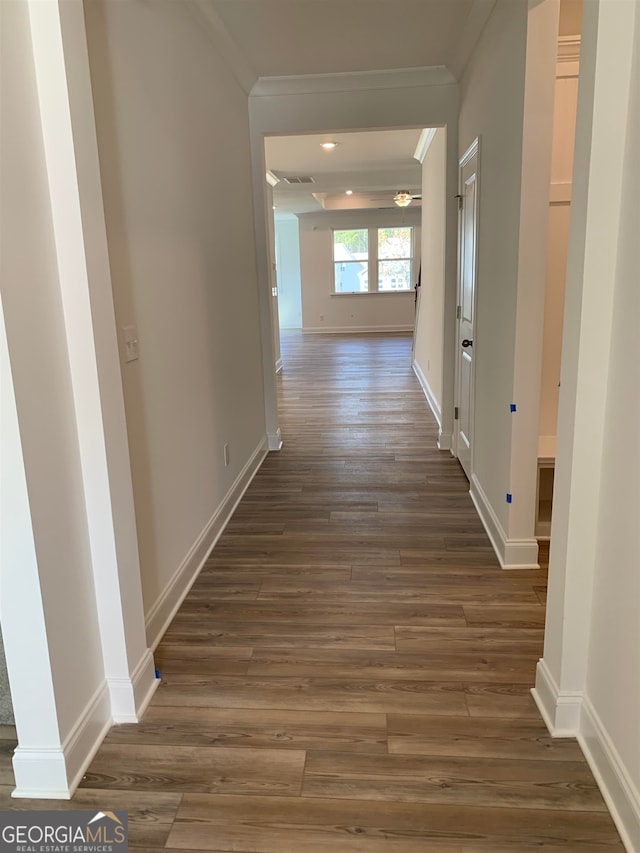 hall featuring ornamental molding and dark hardwood / wood-style floors