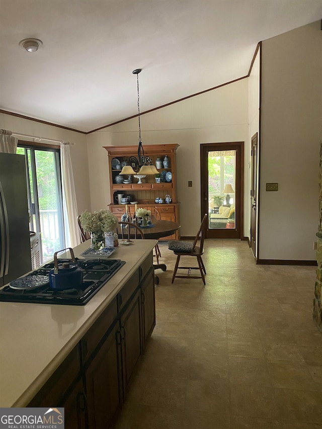 kitchen with hanging light fixtures, vaulted ceiling, plenty of natural light, and black gas stovetop