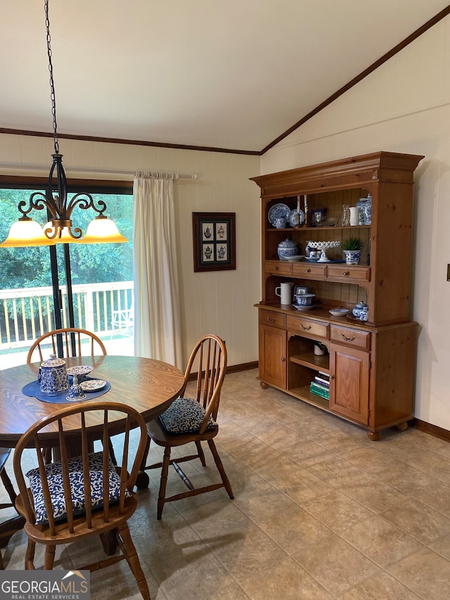 tiled dining space featuring crown molding, lofted ceiling, and a notable chandelier