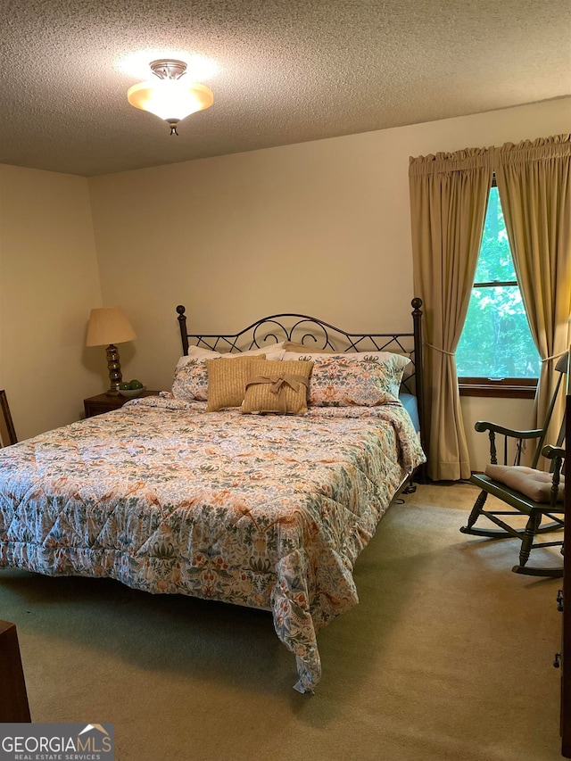 carpeted bedroom featuring a textured ceiling