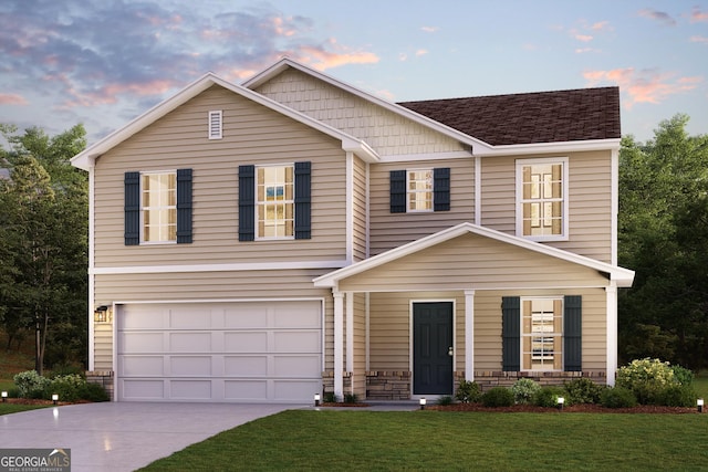 view of front of home with a garage and a lawn